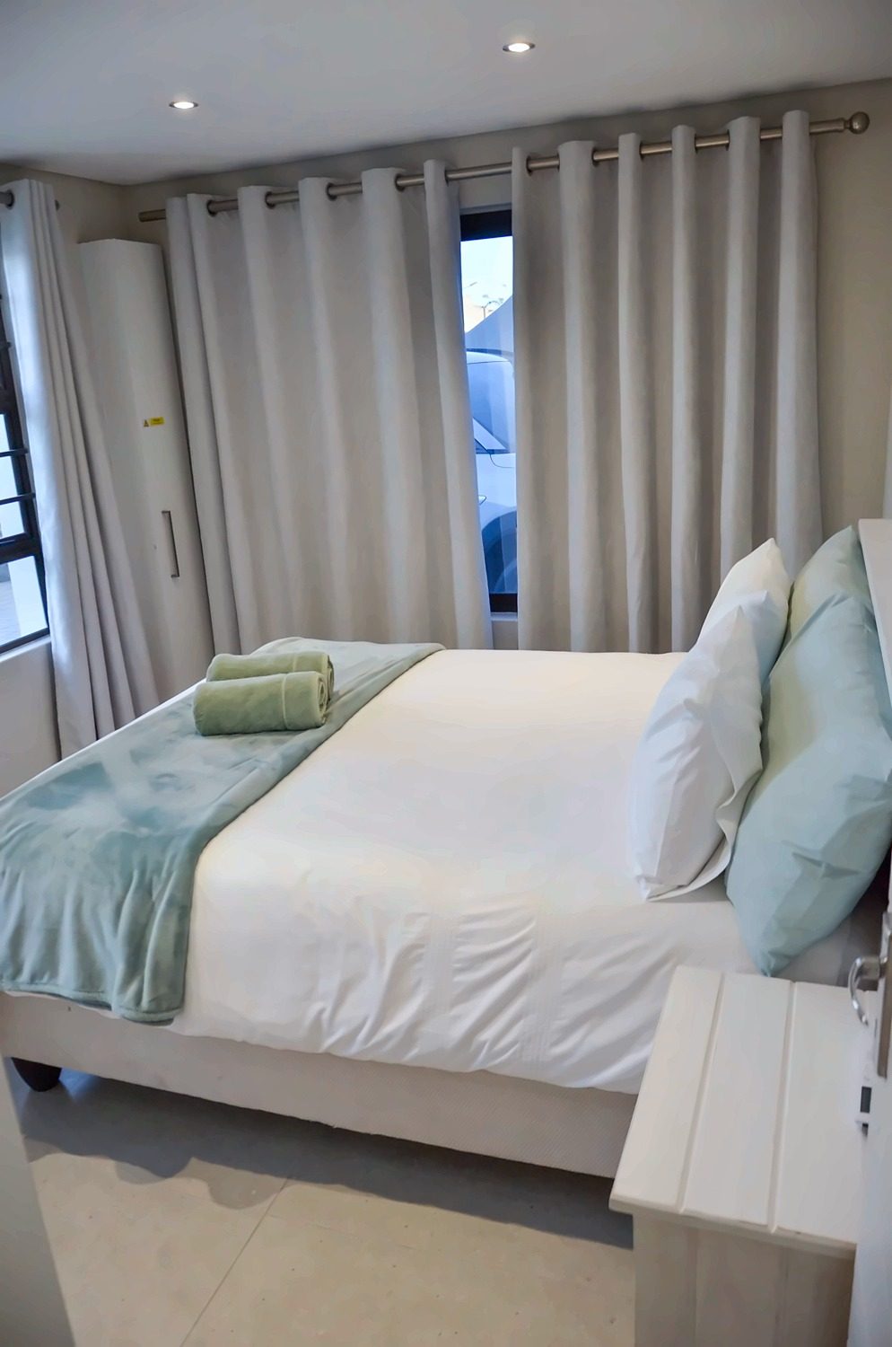 Bedroom 1 with a king bed and curtains