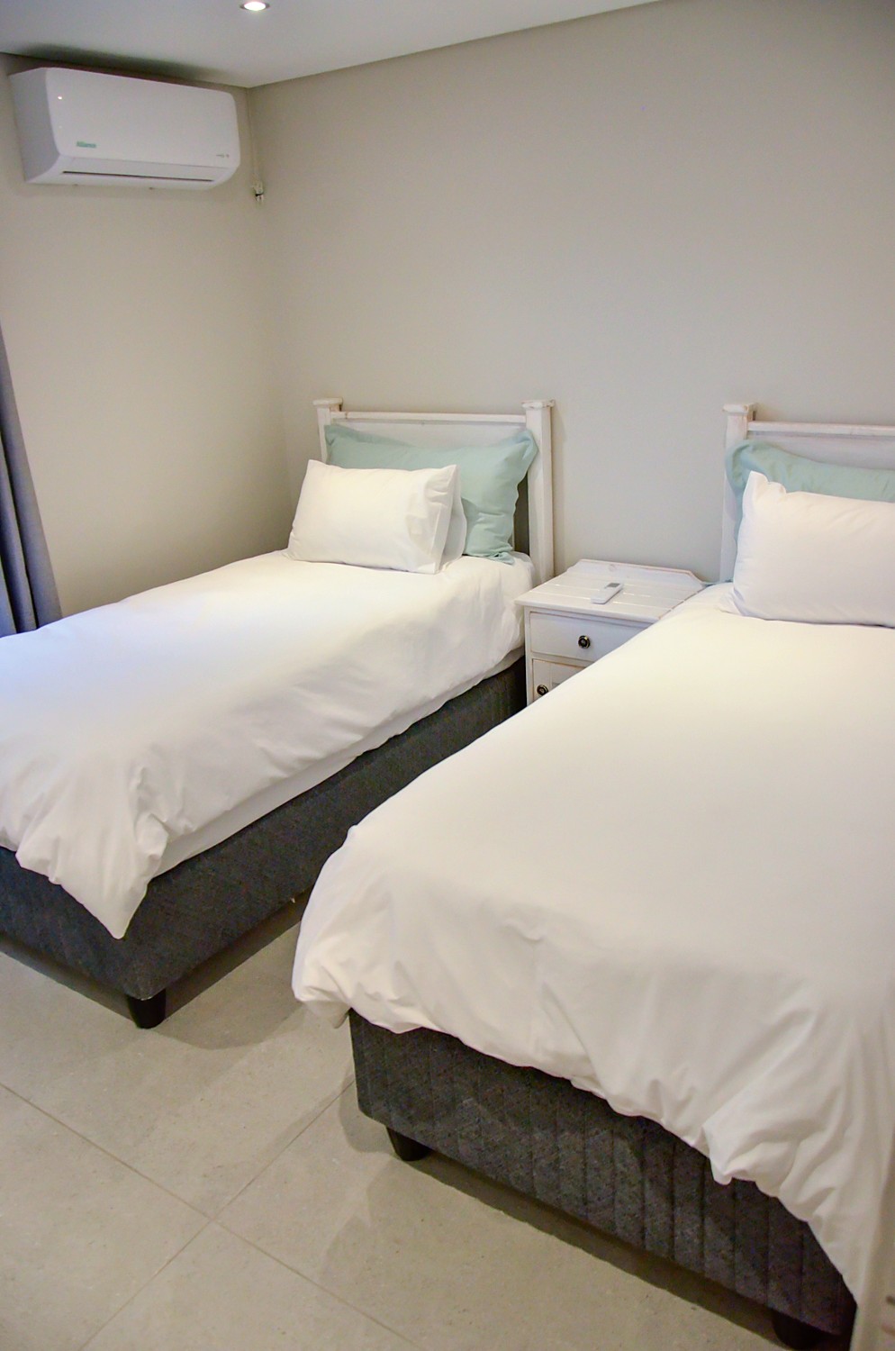 Bedroom 2 with two single beds and air conditioning
