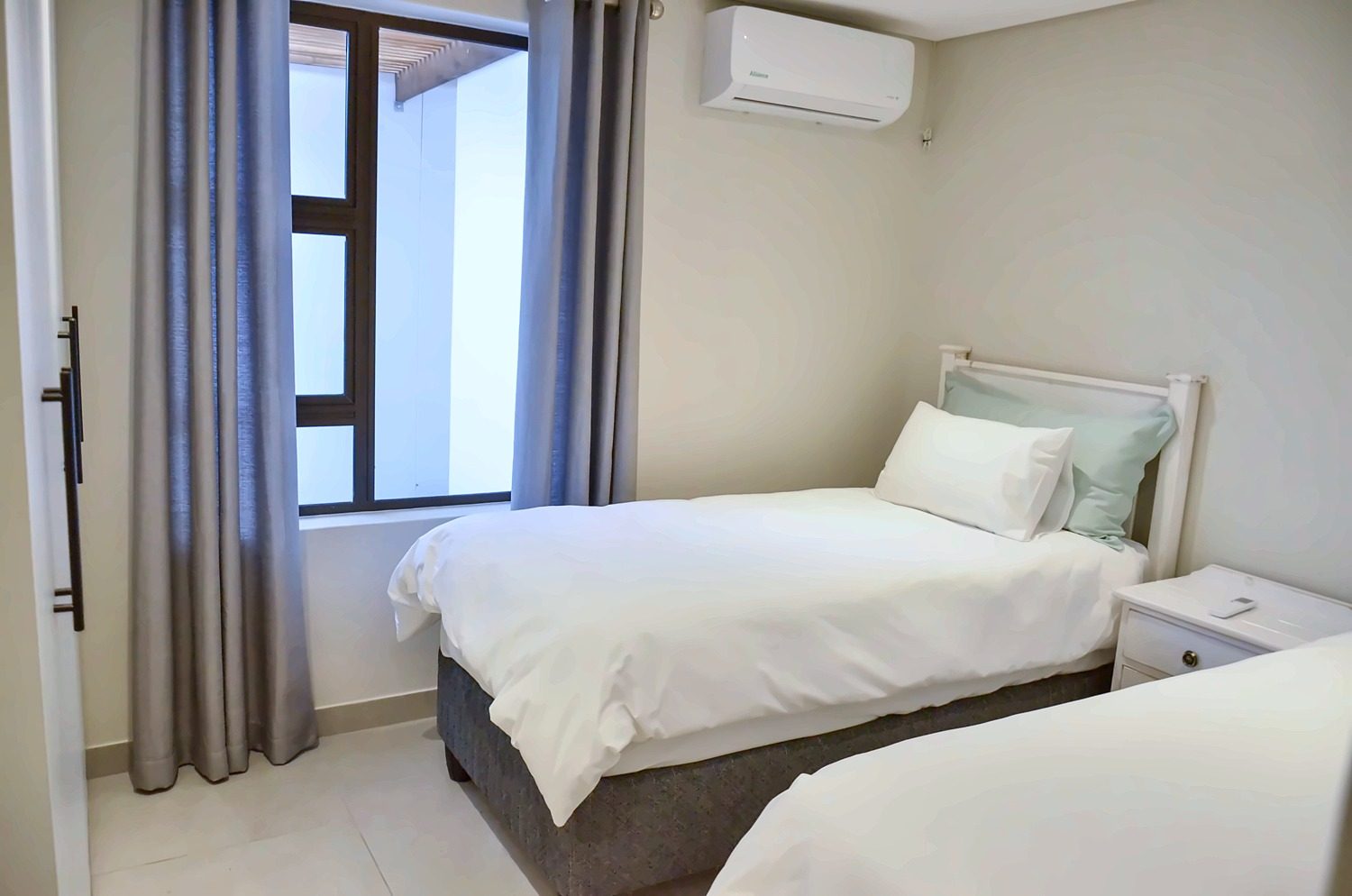 Second view of Bedroom 2 with two single beds