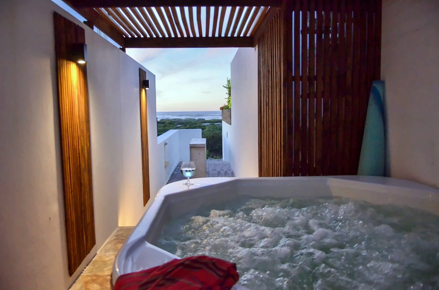 Memory Lane's private jacuzzi under the pergola at sunset with a sea view
