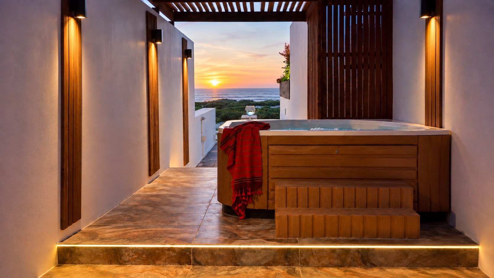 Memory Lane's private jacuzzi at sunset with the sea beyond